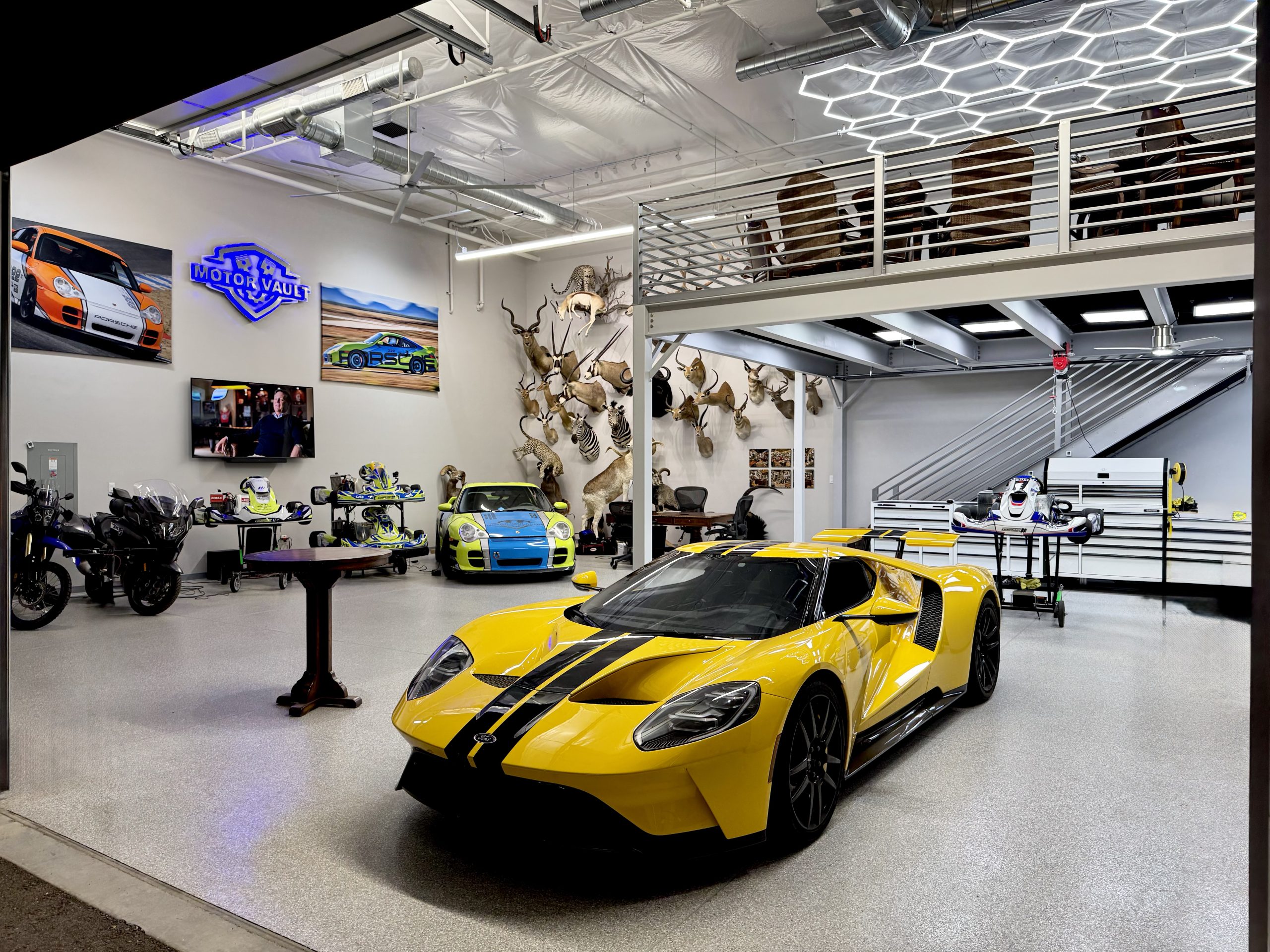 A Jeep and a wooden runabout in a Motor Vault garage suite